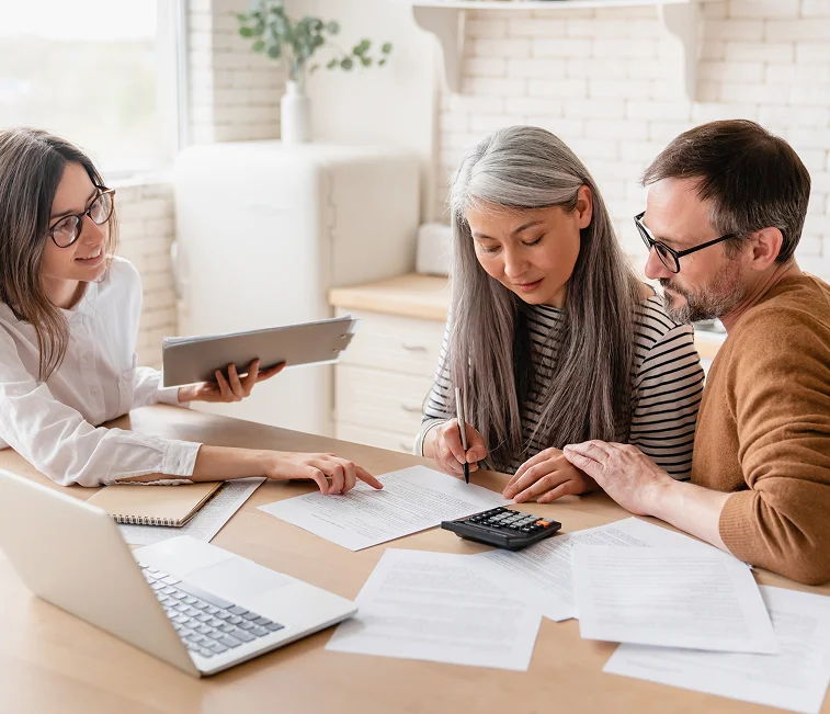 Estate planning attorney in Austin assisting a couple with wills and legal documents at home